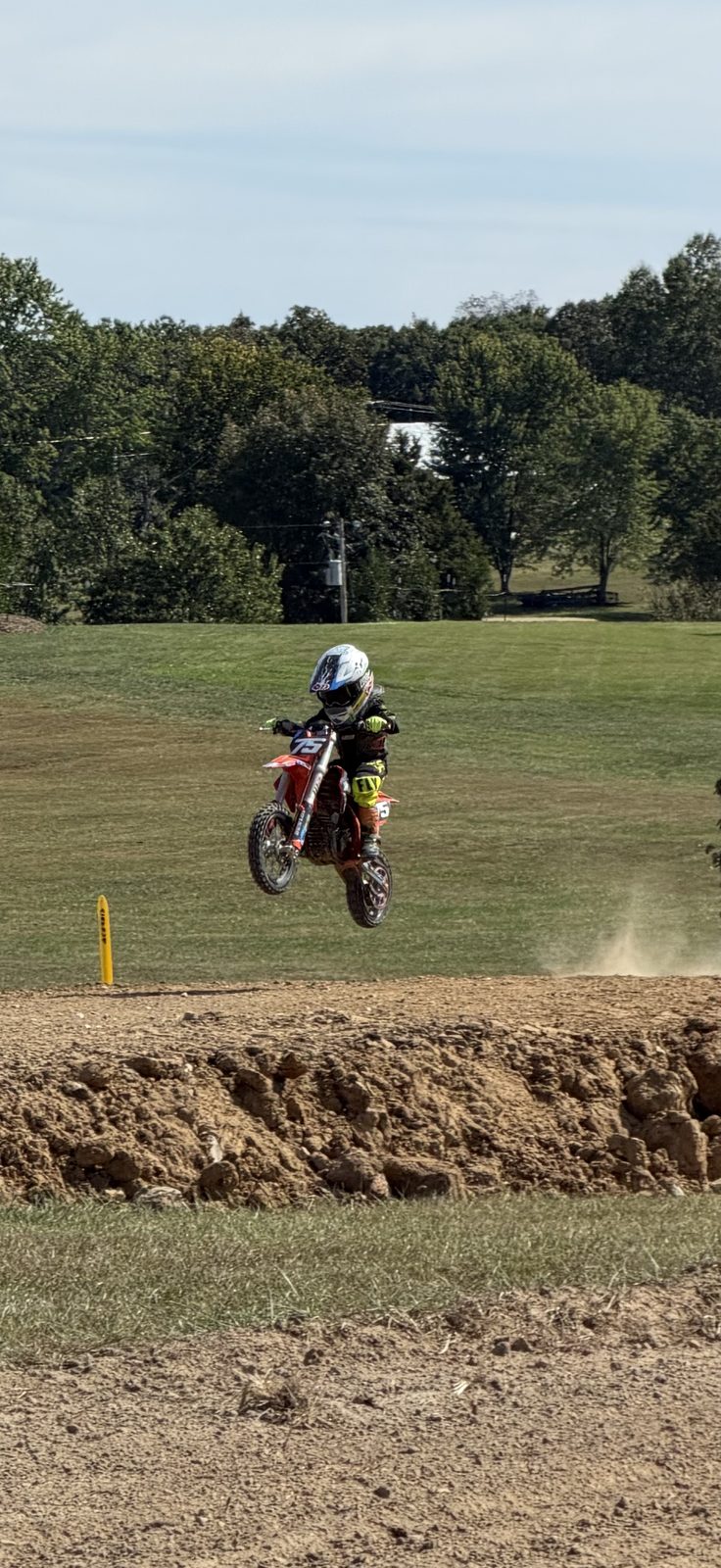 Sawyer #75 in the air over a jump on his red bike